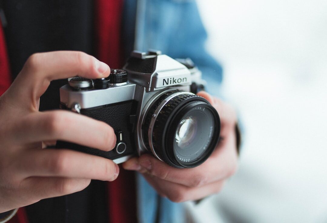 Close-up of hands holding a vintage film camera