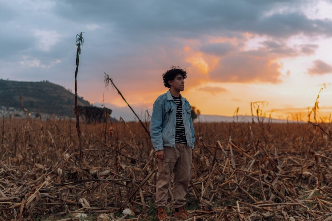 farmer in field at sunset