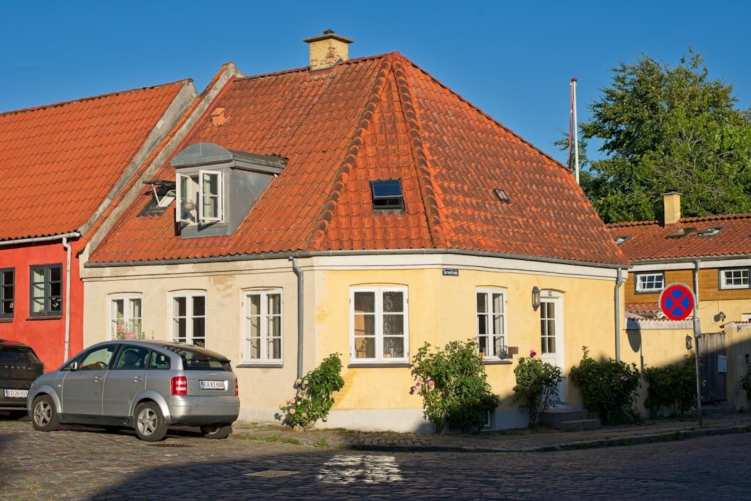 Journalist interviewing an elderly local resident in a Danish coastal town